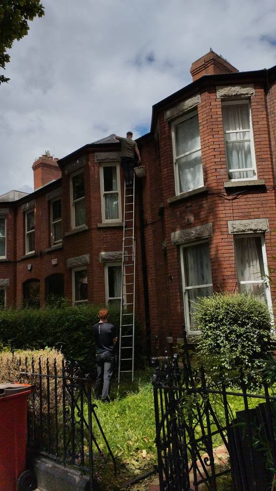 Victorian red brick house where roof works are underway