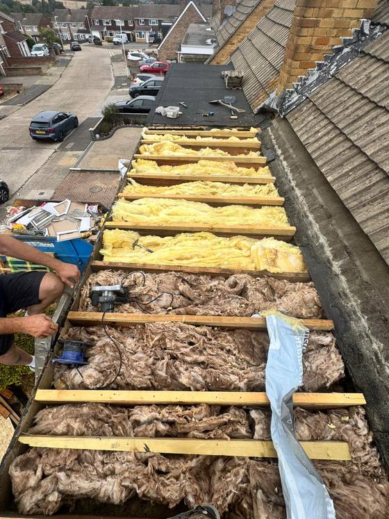 Roof stripped showing battens and insulation from above