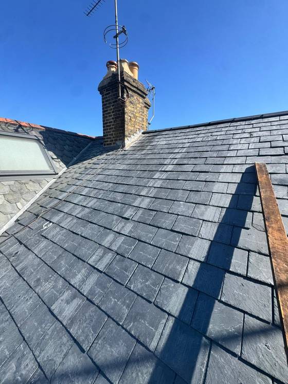 Completed slate roof with chimney stack